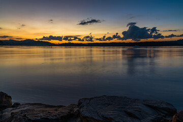 Sunrise waterscape with scattered clouds