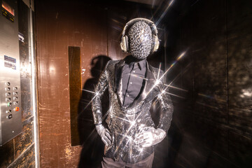 Sparkle masked man dancing in a lift