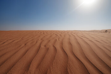 Sunset over the sand dunes in the desert.