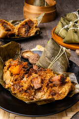 Zongzi or Bakcang is a traditional Chinese rice dish made of glutinous rice stuffed with different fillings and wrapped in bamboo leaves. They are cooked by steaming or boiling