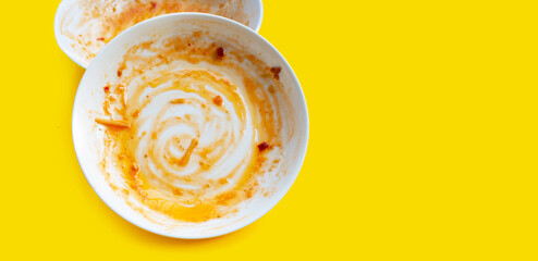 Dirty dishes on yellow background.