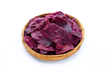 Purple sweet potato chips in bamboo basket on white