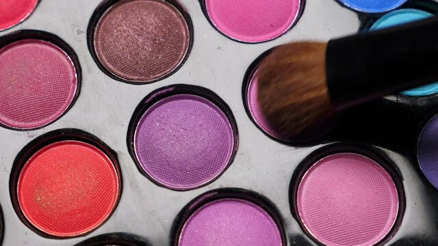 Taking color from Professional makeup eyeshadows palette for make-up artist, closeup