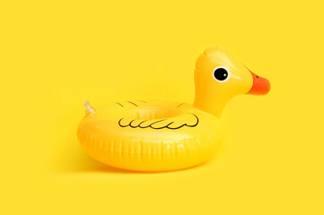 Inflatable of yellow duck on yellow background. Summer background concept
