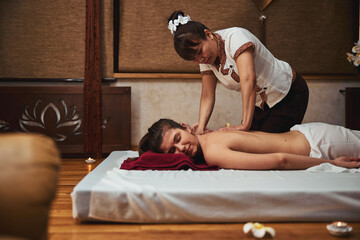 Female under the massage of spa salon professional