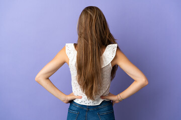 Young caucasian woman over isolated background in back position