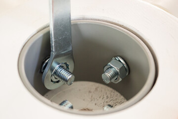 Asian man assembling white table furniture at home