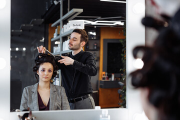 Stylist to make a hairstyle in the style of the 80's. Laying. hair.
