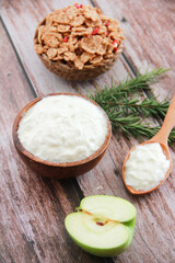 white milk yogurt in a wooden plate and spoon