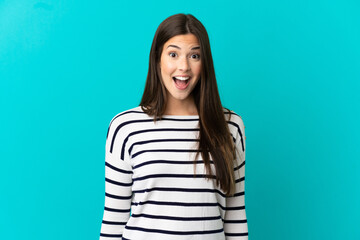 Fototapeta premium Teenager Brazilian girl over isolated blue background with surprise facial expression