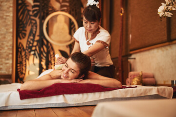 Relaxation of cheerful female during herball ball procedures