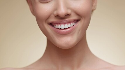 Closeup of woman smiling to camera, showing white smile of after teeth alignment procedure, beige background - Powered by Adobe