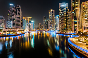 Fototapeta na wymiar Dubai, UAE – April 19, 2021: night view on Dubai Marina Bay, tall buildings