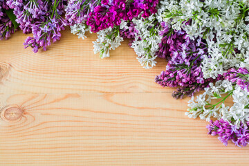 Colorful lilac flowers on wooden background