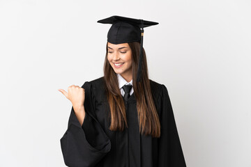 Teenager Brazilian university graduate over isolated white background pointing to the side to present a product