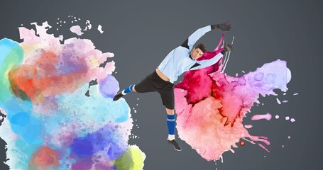 Composition of football goalkeeper over colourful splodges and grey background