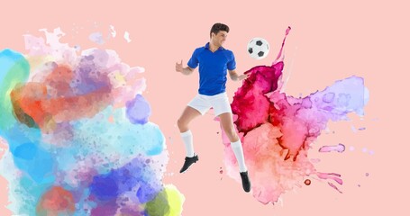 Composition of football player with ball over colourful splodges and pink background