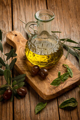 olive oil bottle with leaf and black olives