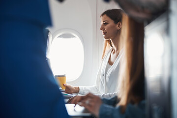 Female sitting with coffee on her plane seat