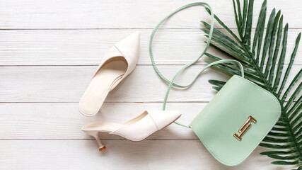 Fashion bag  woman accessories wood white background. Trendy fashion luxury yellow handbag design with monstera leave green. Lifestyle and Beauty Concept