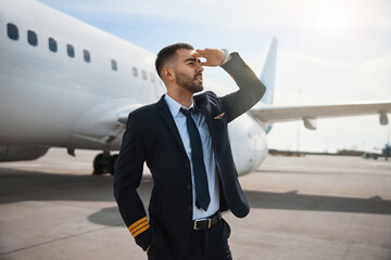 Male airplane pilot covering his eyes while watching ahead © Viacheslav Yakobchuk