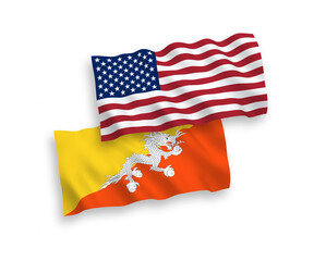 Obraz premium National vector fabric wave flags of Kingdom of Bhutan and USA isolated on white background. 1 to 2 proportion.