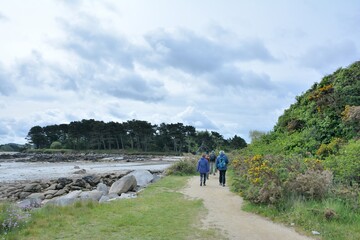 group of senior hikers on the path at Landrellec in Brittany. France