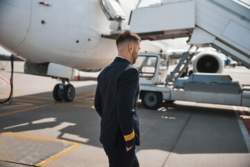 Pilot walking away to airstairs of aircraft