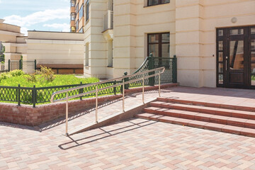 The staircase to the entrance is equipped with stainless steel handrails and a gentle descent and...