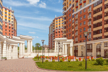 A modern residential complex with a landscaped area.