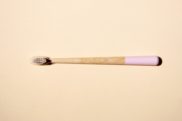 One bamboo toothbrushes on light background. Top view.