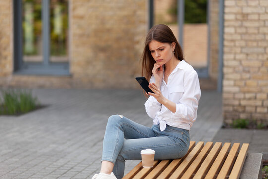 Social media haters. Upset girl with phone, alarming symptoms. Bullying on the Internet. - Powered by Adobe