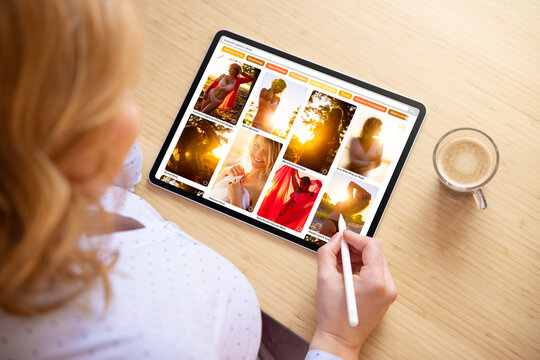 Woman browsing photos online on tablet computer