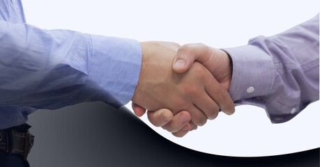 Mid section of two businessman shaking hands against technology background