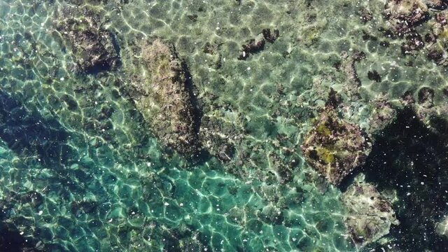 Aerial view. Clear blue sea water with stone rocky shore. Spanish coast nature. Mediterranean Sea.