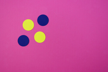 Yellow and blue circles from paper on a pink background. Abstract bright background with circles. 