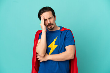 Super Hero caucasian man isolated on blue background with headache © luismolinero