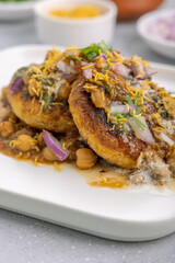 Aloo Tikki or Cutlet or Aloo Patties  dipped in Chickpea curry