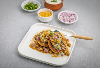 Aloo Tikki or Cutlet or Aloo Patties  dipped in Chickpea curry