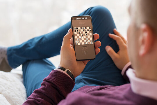 Man playing chess online on mobile phone