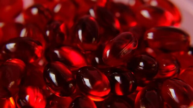 Krill oil gelatin capsules close-up  on a pink background. Rotation.omega fatty acids.Natural supplements and vitamin