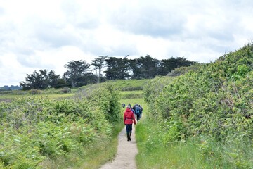 group of senior hikers on the path at Landrellec in Brittany. France
