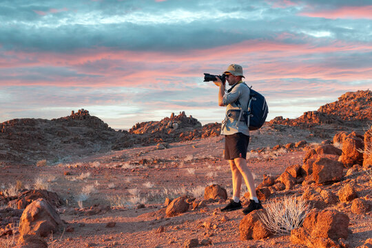 Photographer taking photo in rocks of Namib Desert