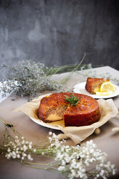 Banana cheese cake with hand holding knife and cutting it.