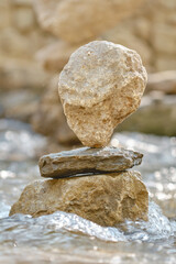 Balanced stones in river water. Shallow depth of field
