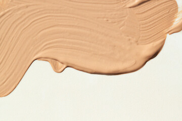 Liquid make up foundation or concealer smear close up. Beauty cosmetic abstract