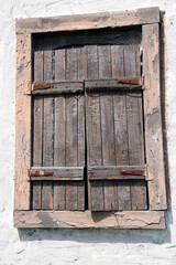 old wooden window with closed shutters