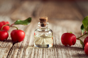 A bottle of wintergreen essential oil with wintergreen plant and berries