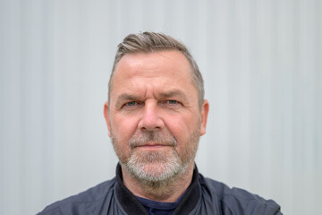 Sincere middle-aged man looking at camera with empathy