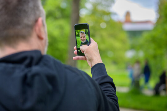 Man checking a selfie image on the screen of his mobile